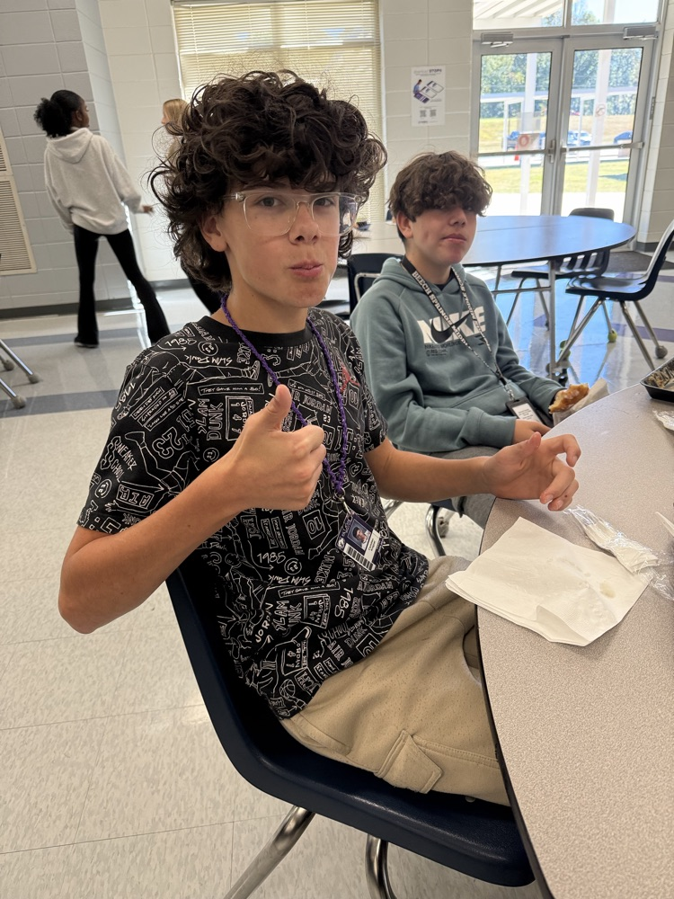 two students eating donuts 
