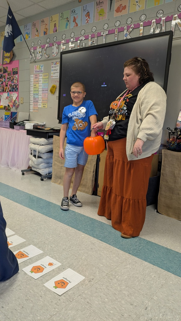 students pulling shapes out of a bucket to match