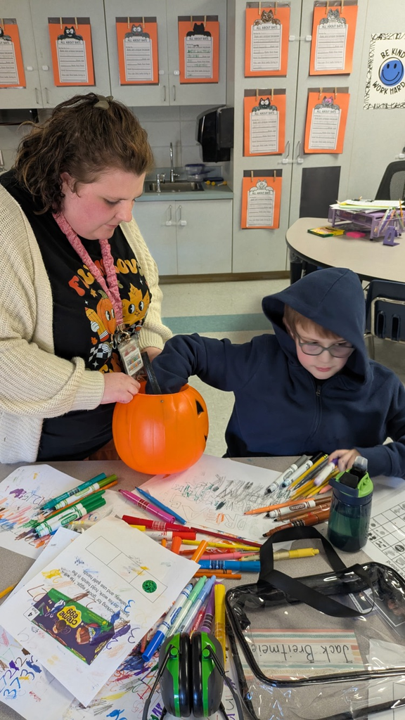 students pulling shapes out of a bucket to match