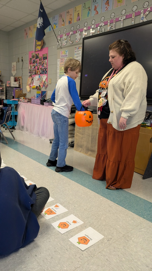 students pulling shapes out of a bucket to match