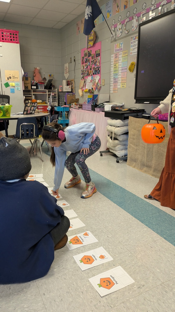 students pulling shapes out of a bucket to match