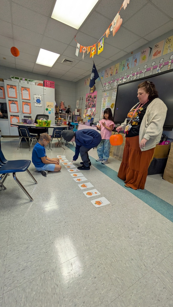 students pulling shapes out of a bucket to match