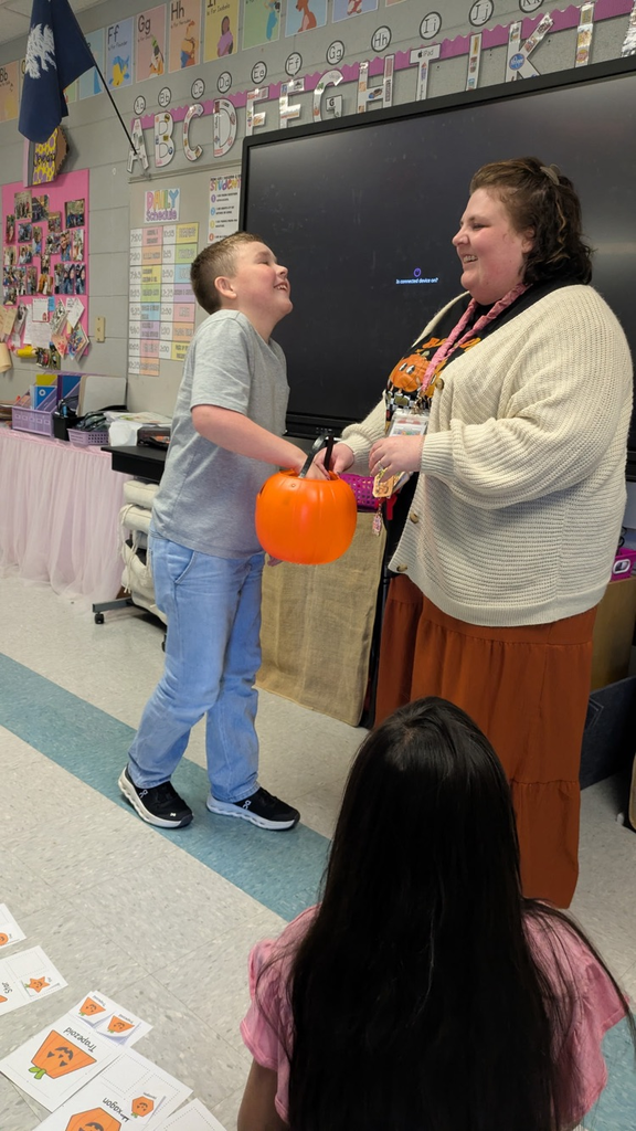 students pulling shapes out of a bucket to match
