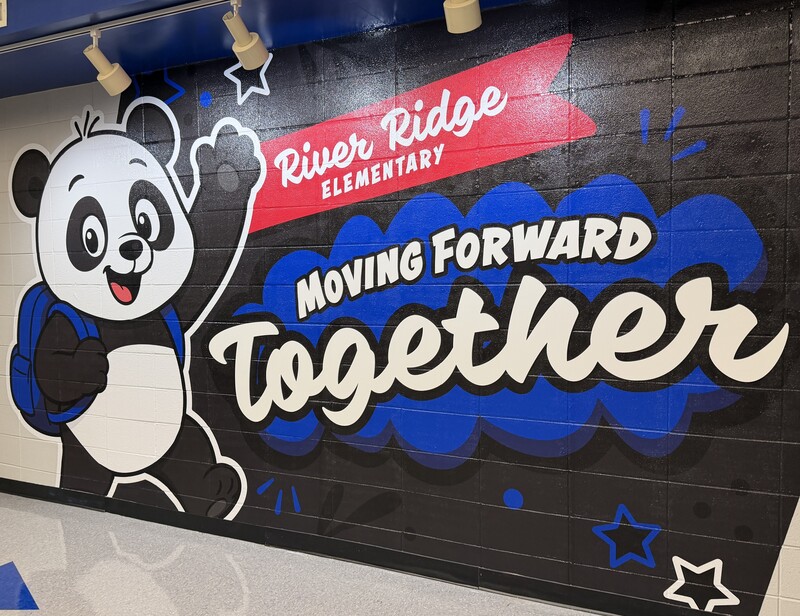 new mural on the wall with panda and school name