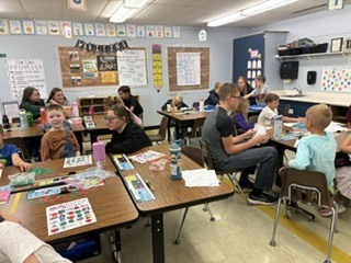 Spearfish High School government students working in classrooms with students.
