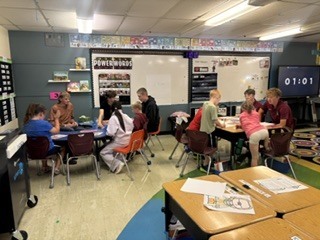 Spearfish High School government students working in classrooms with students.