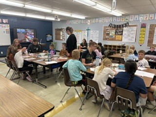 Spearfish High School government students working in classrooms with students.