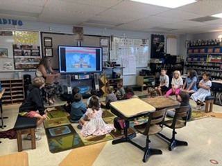 Spearfish High School government students working in classrooms with students.