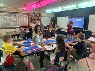 Spearfish High School government students working in classrooms with students.