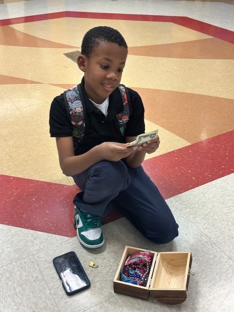 Picture of student with prize winnings.