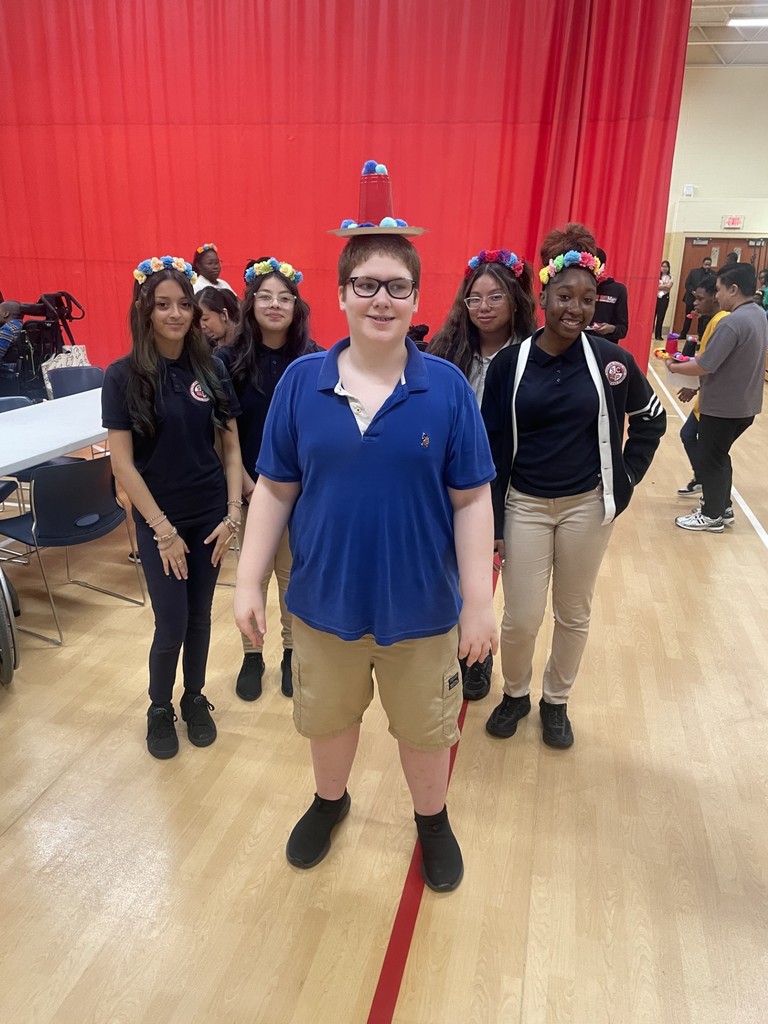 Students with hats and flower wreaths.