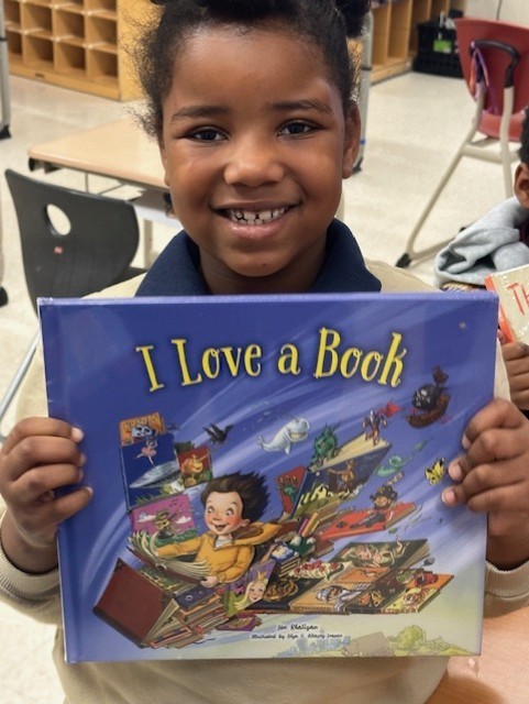 Picture of student with a book.