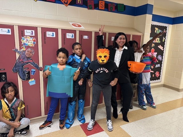 Students and teacher dressed up for Halloween.