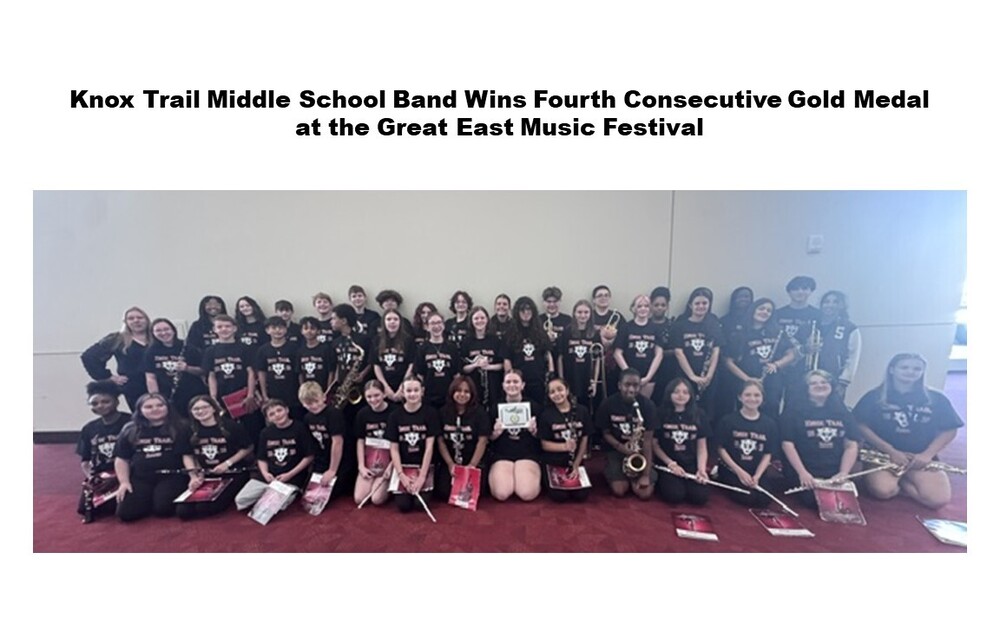 Middle school band members dressed in black sitting in group on red carpet