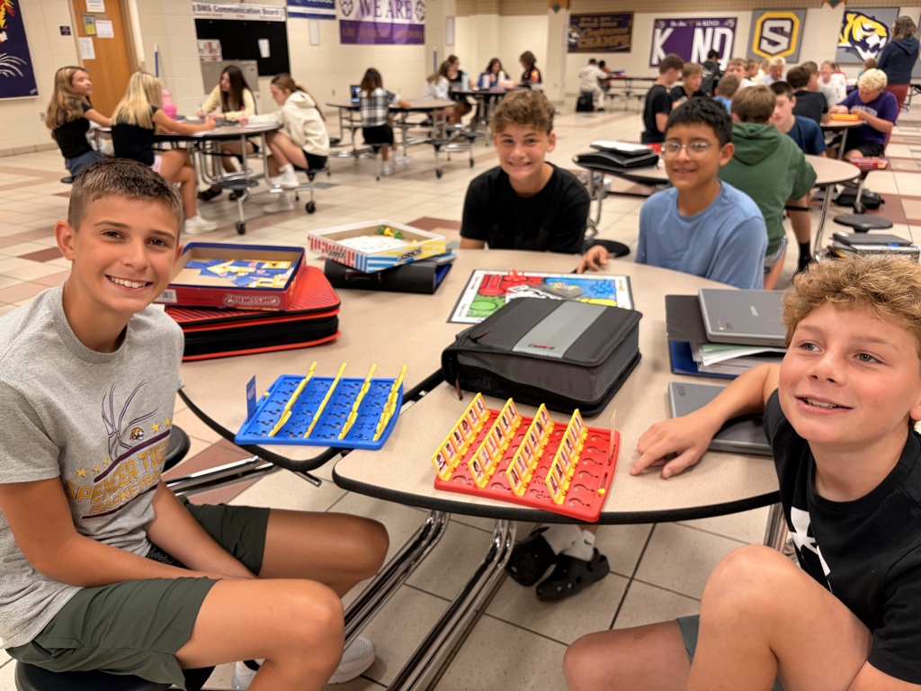 A group of middle school students playing board games.