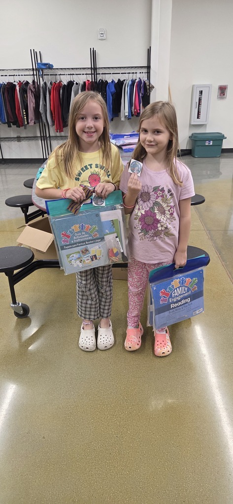 Elementary students with reading packets.