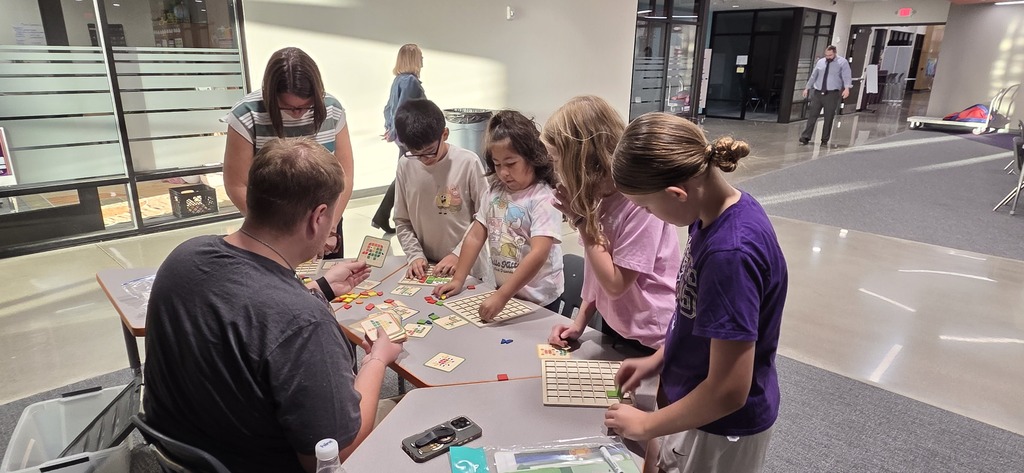 Elementary students at a math activity station.