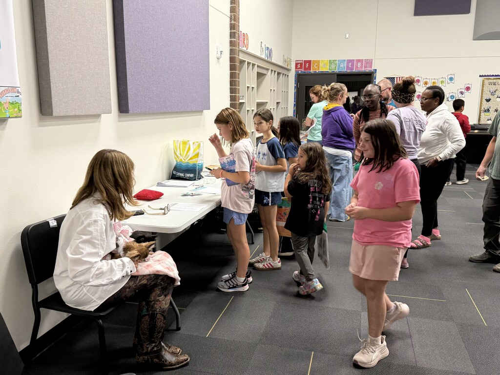 Elementary students at math and literacy activity stations.