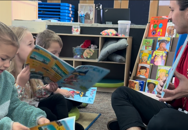 Teacher reading to students.