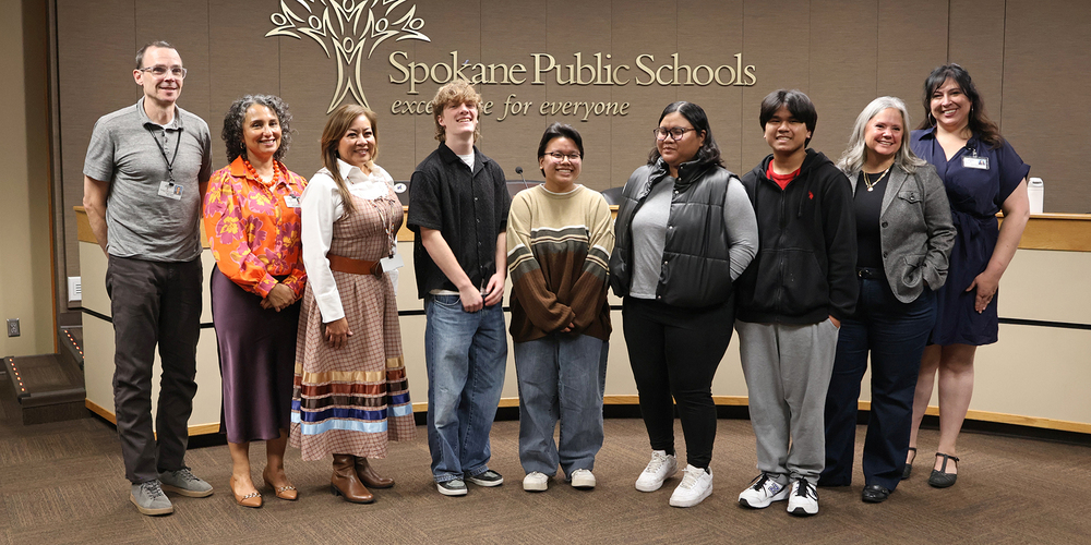 School Board members smile with new Student Advisors and their family.