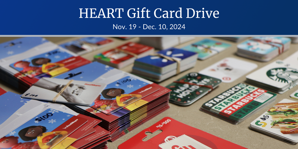 Stacks of an assortment of gift cards with prices between $15 and $100 arranged on a table with the text "HEART Gift Card Drive, Nov. 19-Dec. 10, 2024."