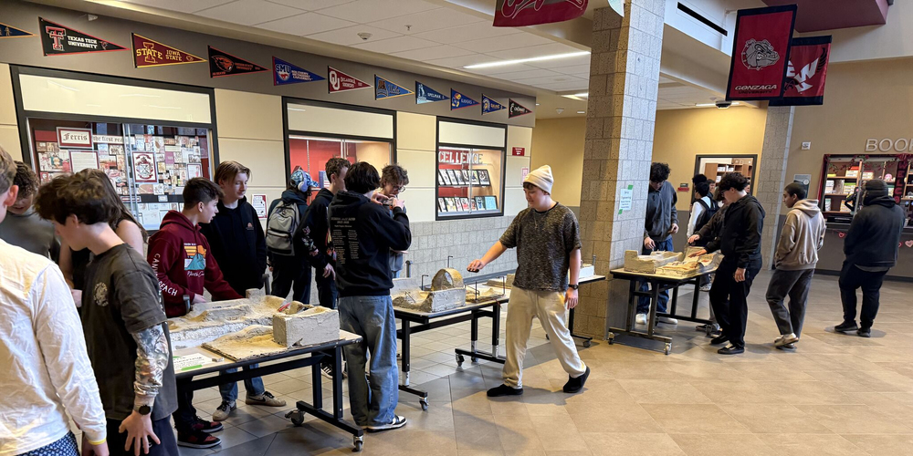 Ferris High School students explore student-made concrete models of skate parks.