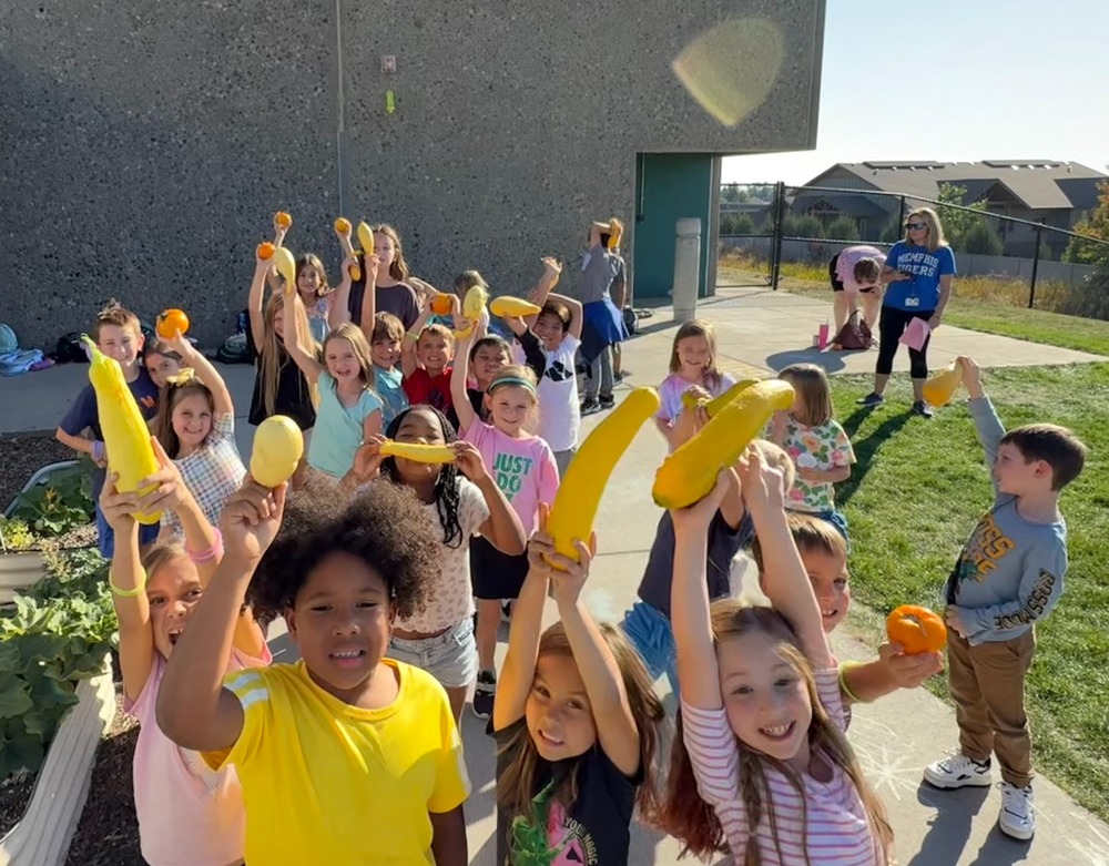 Students holding up squash