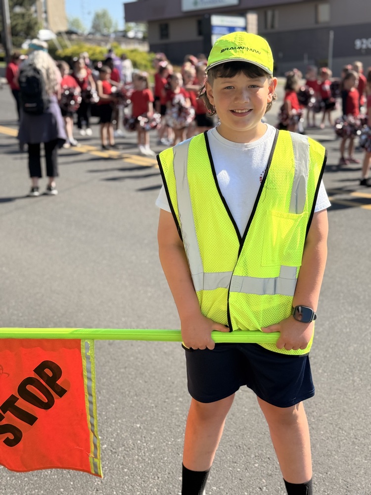 Student holding crossing flag