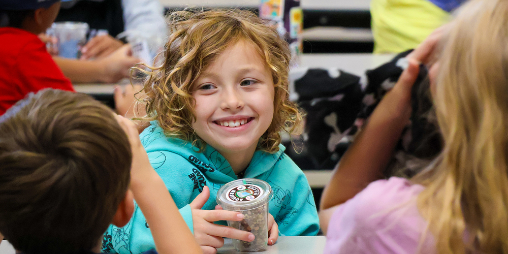 Kid smiling at table