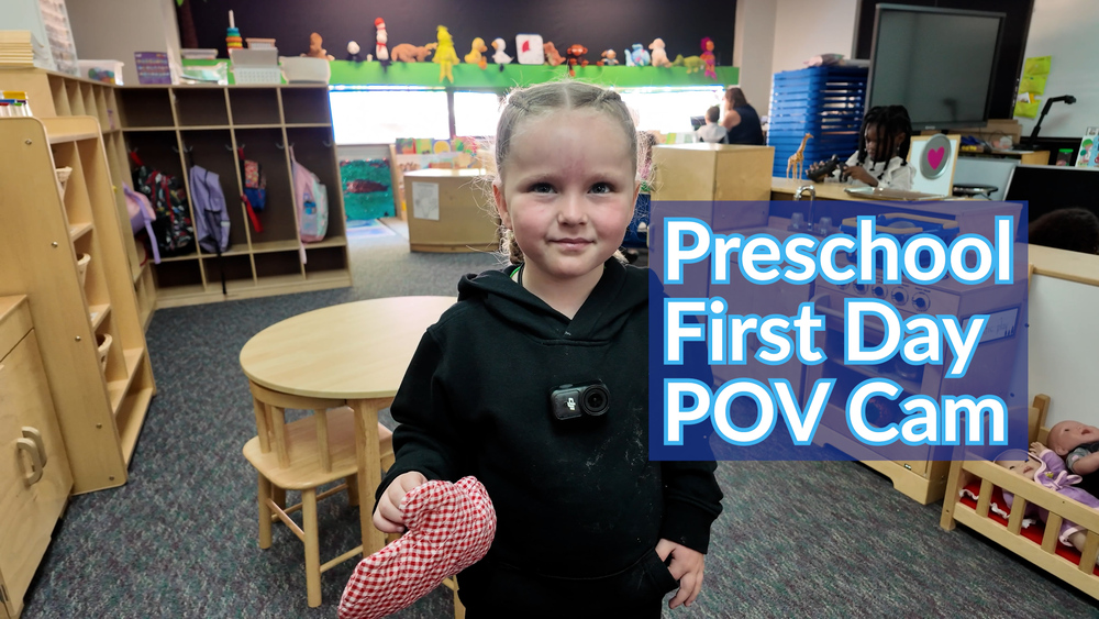 A preschool student smiles in a classroom with text about a first day of school POV Cam