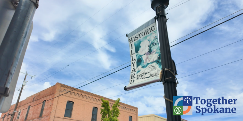 A photo of a banner with the words Historic Hillyard, and a Together Spokane logo.