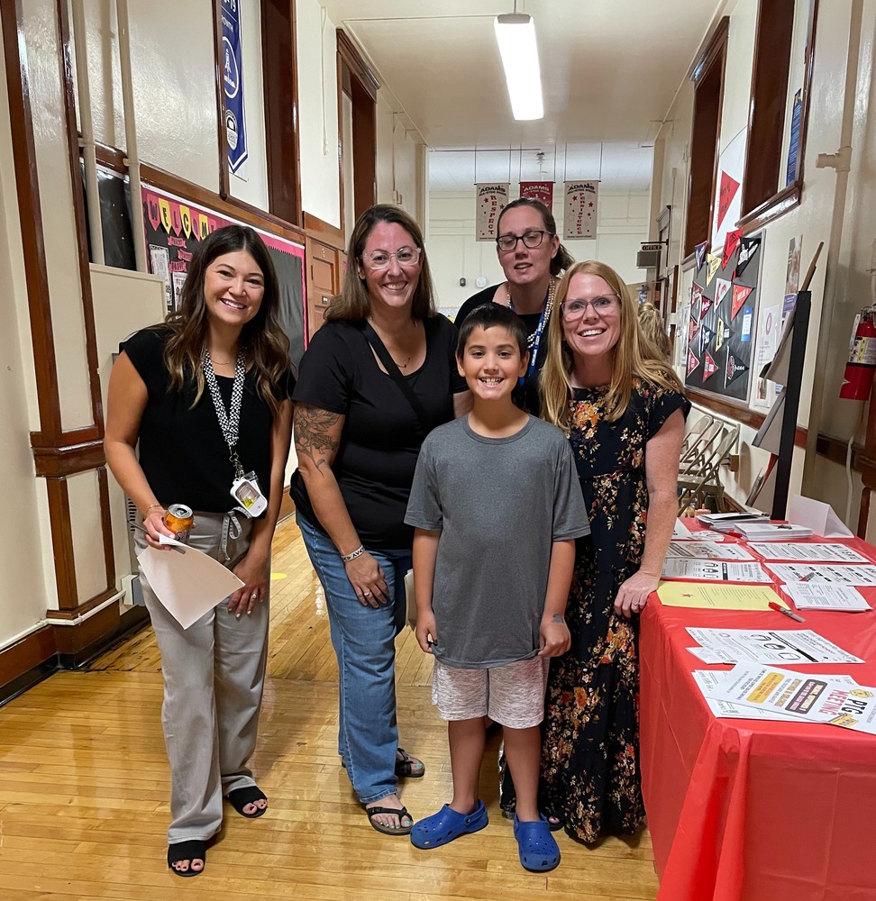 Staff, families, and students smiling.