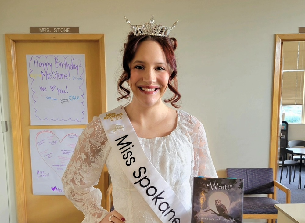 Miss Spokane Holding Book 