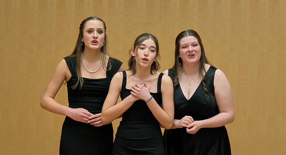 Three Ferris High School vocal students sing at a competition.