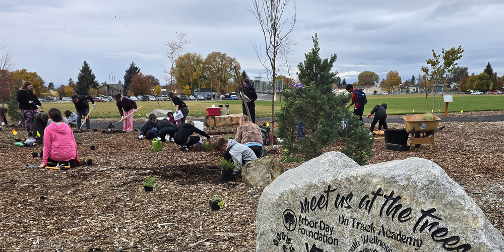  OTA students plant a community forest on campus with Shaw Middle School students.