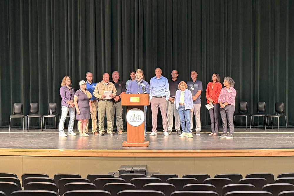 Local officials gather on stage at Shadle Park High School