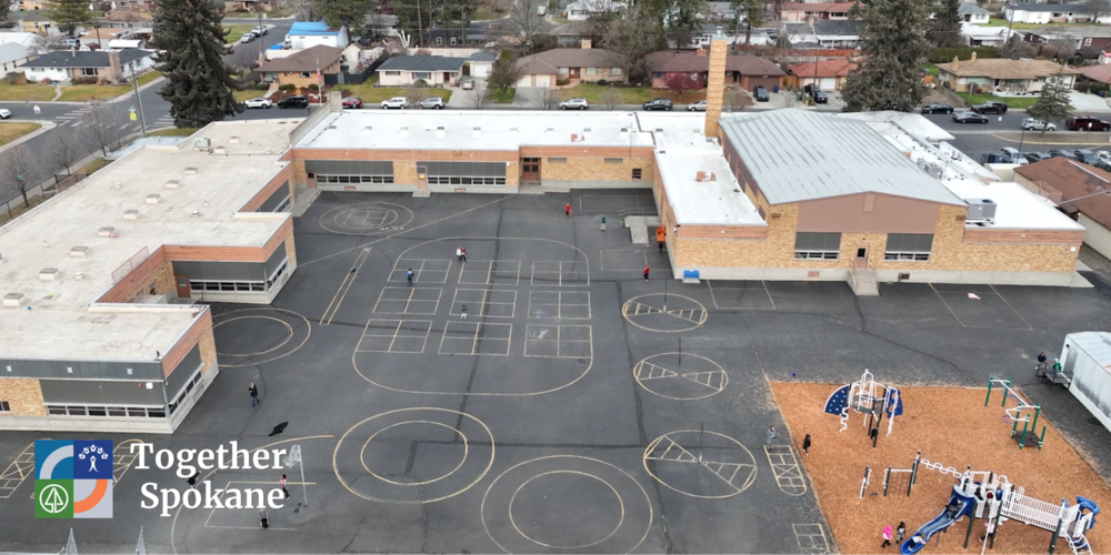 View of Madison Elementary School blacktop with Together Spokane logo