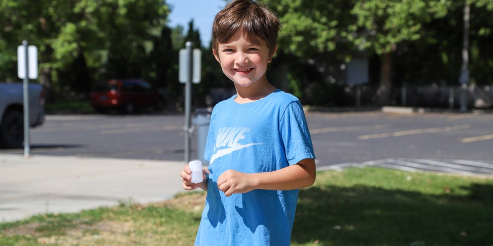 Kid outside smiling