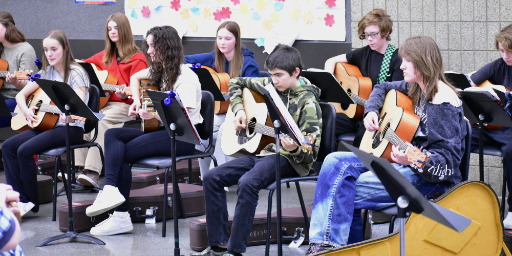 students playing guitars