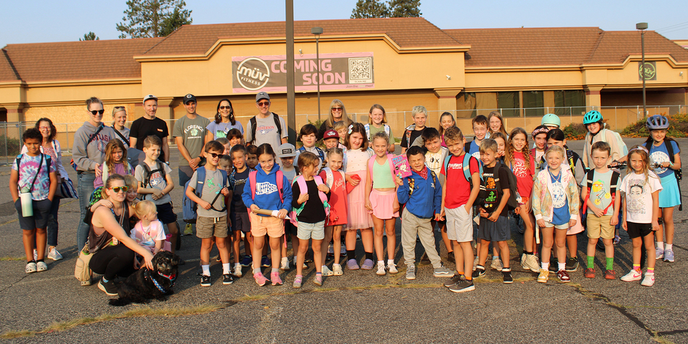 A group of about 50 elementary students, teachers, and staff gathered for photo.
