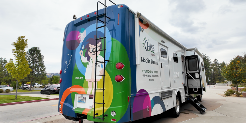 CHAS Health Mobile Dental Clinich with a colorful hedgehog mascot mural on the back.