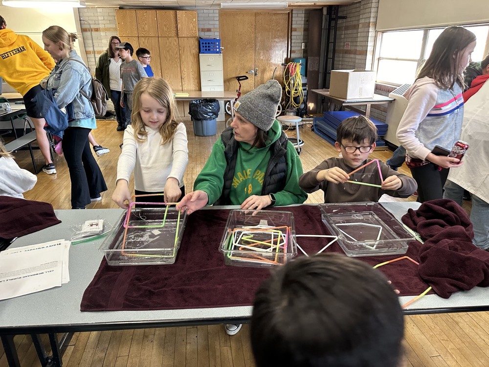 Students doing science experiments at STEAM night