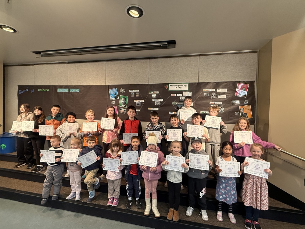 Students holding up award certificates