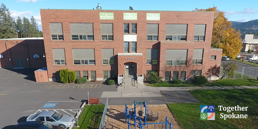 A view of Adams Elementary School with a Together Spokane logo.