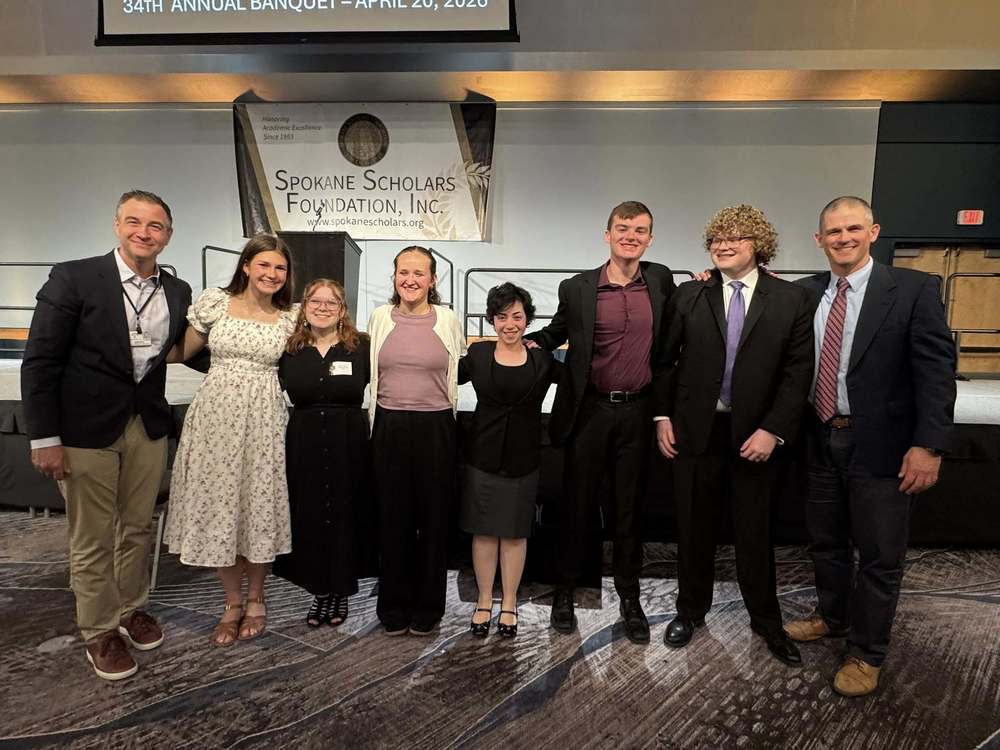 Six Spokane Scholars from Ferris High School smile with Principal John O'Dell and Superintendent Adam Swinyard.