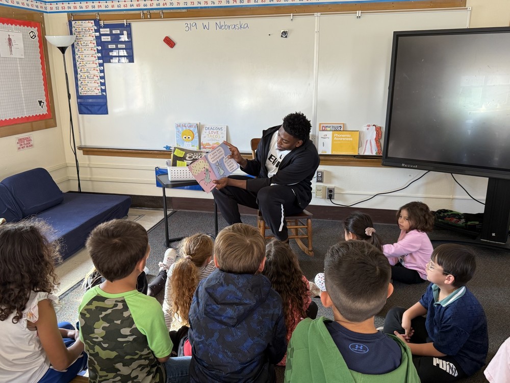 EWU basketball player reading to 1st grade students