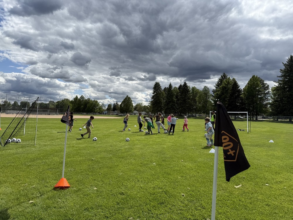 Students playing soccer at a soccer camp