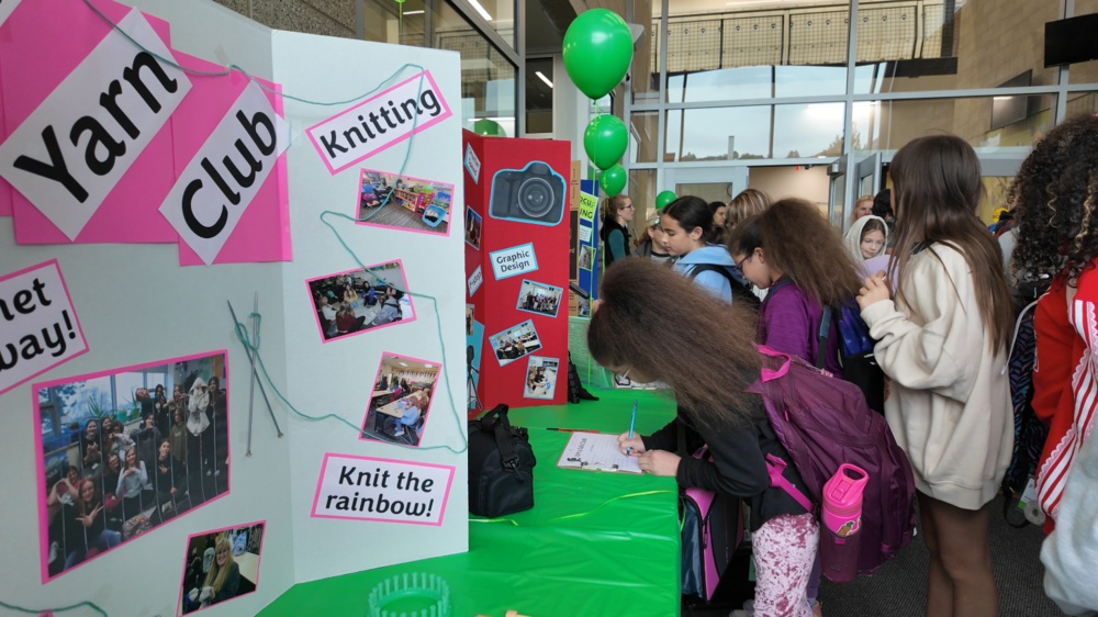 Students sign up for activities as a middle school club fair.