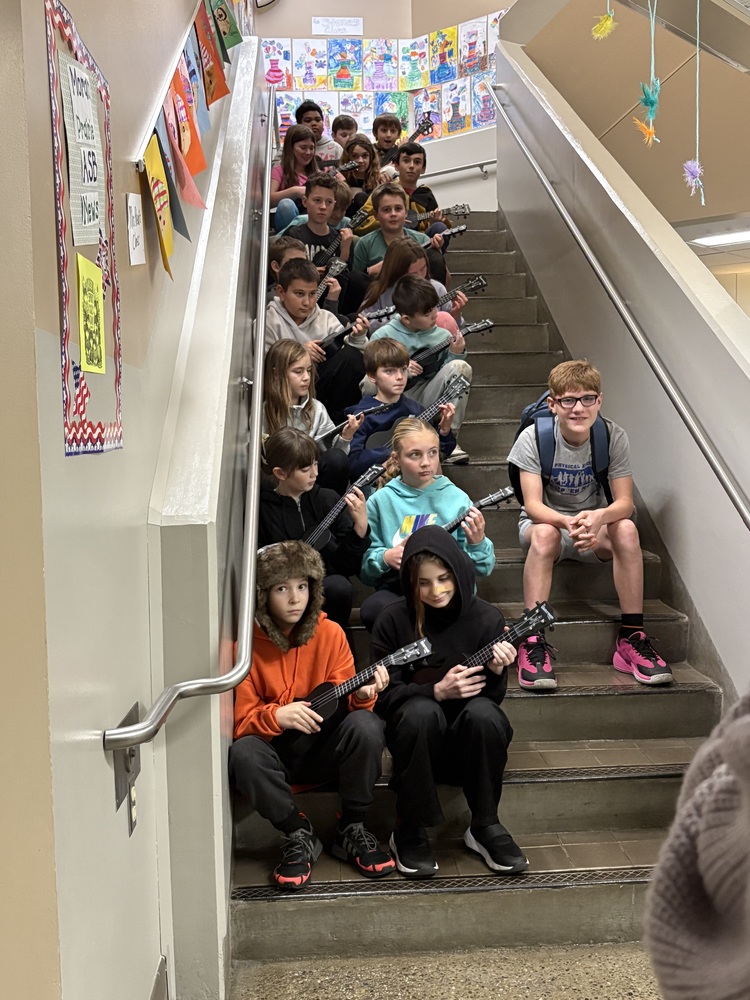 Students on stairs with instruments