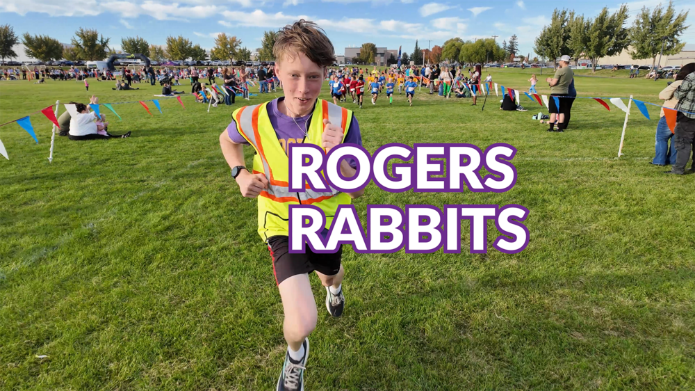 A high school runner races ahead of elementary students; text reads Rogers Rabbits.